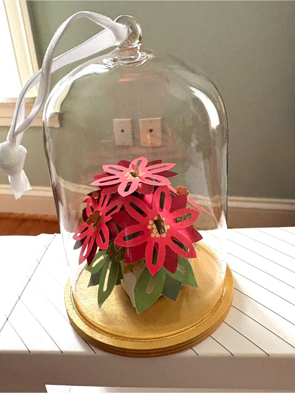 Hallmark Red and Green Poinsettia in glass bell with golden wood base.